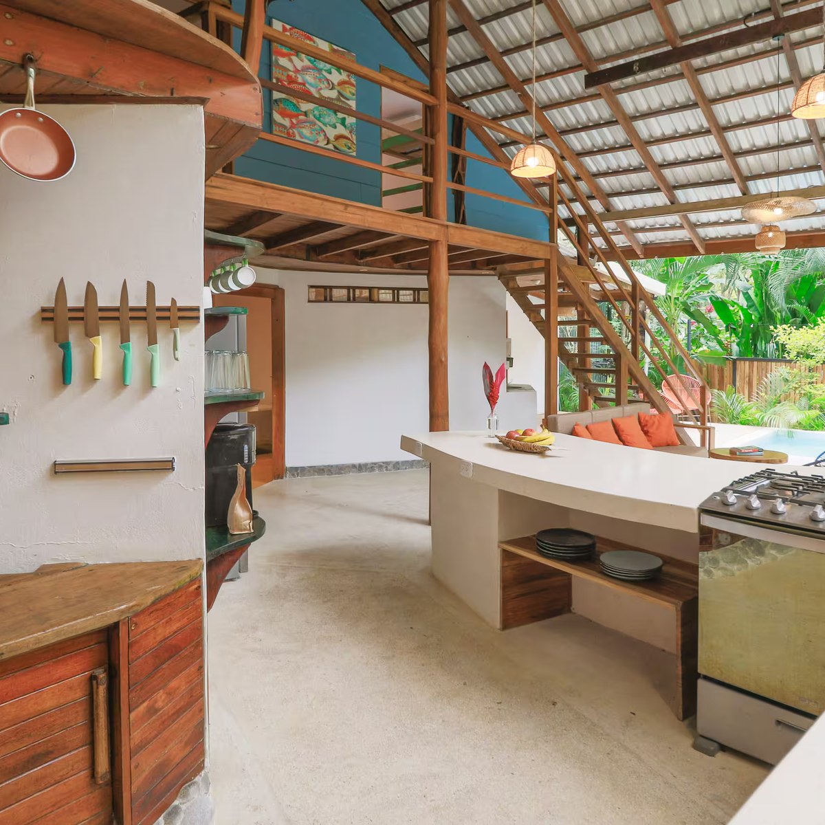The open kitchen, with copper pans and a view through to the garden