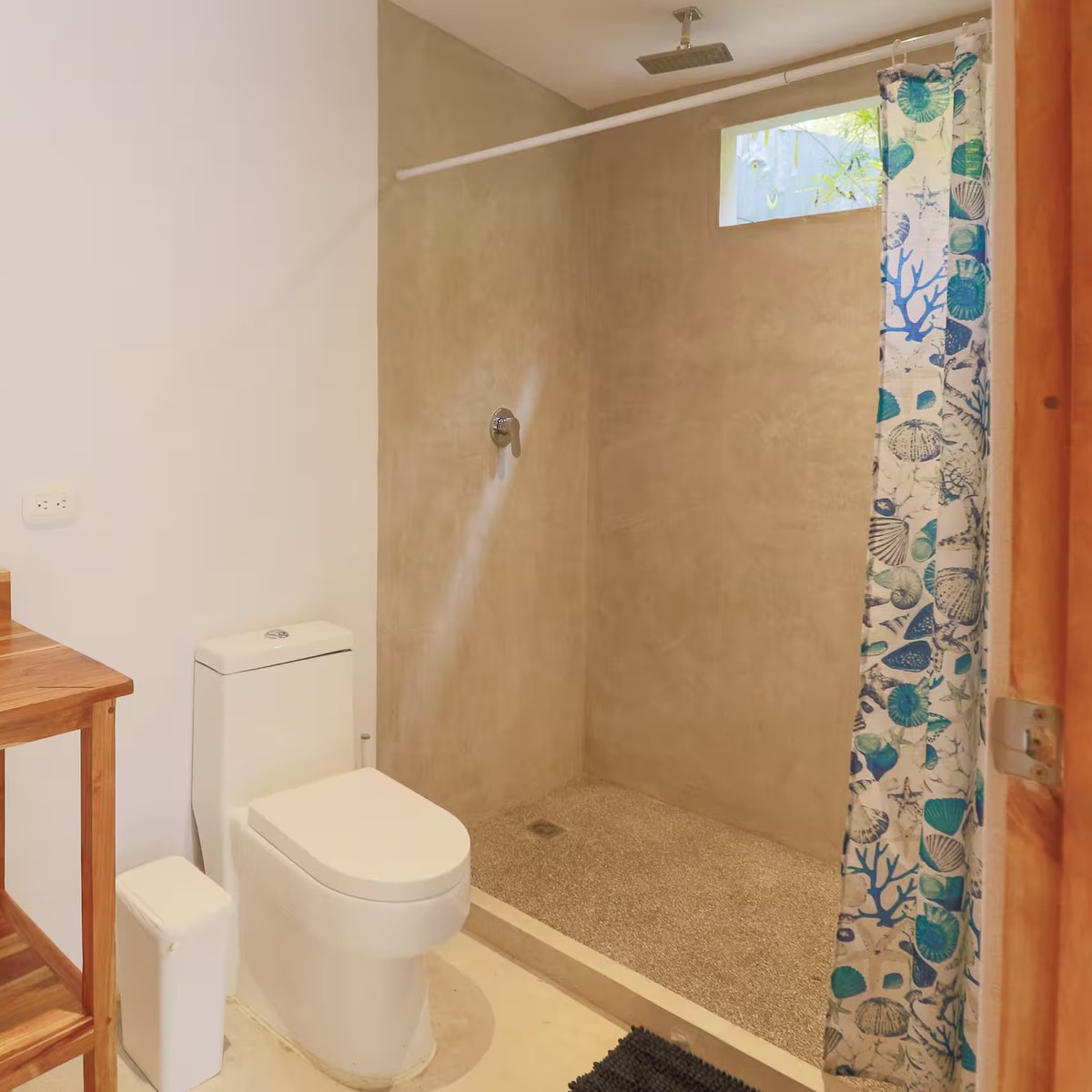 A bathroom with an open stone shower